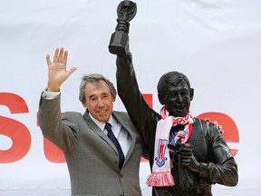 In this July 12, 2008 file photo former England soccer goalkeeper Gordon Banks stands next to the Gordon Banks statue at the Britannia Stadium in Stoke, England. (Dave Thompson/PA via AP, File)