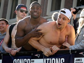 In this Tuesday, Feb. 5, 2019 file photo, New England Patriots tight ends Dwayne Allen, left, and Rob Gronkowski react to fans during the team's parade through downtown Boston to celebrate their win over the Los Angeles Rams in Sunday's NFL Super Bowl 53 football game in Atlanta.