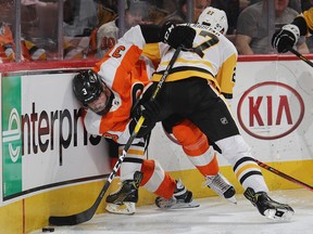 Nick Bjugstad of the Pittsburgh Penguins hits Radko Gudas of the Philadelphia Flyers into the boards at the Wells Fargo Center on February 11, 2019 in Philadelphia. (Bruce Bennett/Getty Images)