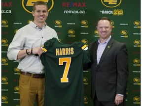 Edmonton Eskimos newly acquired quarterback Trevor Harris (left) receives an Eskimos jersey from general manager Brock Sunderland (right) in the team dressing room at Commonwealth Stadium on Thursday Feb. 14, 2019.