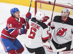 Canadiens' Charles Hudon moves in on New Jersey Devils goaltender Mackenzie Blackwood as Devils' Andy Greene defends in Montreal on Saturday, Feb. 2, 2019.