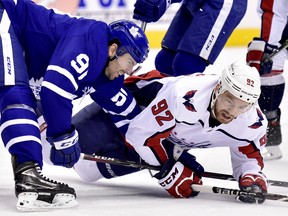 Toronto Maple Leafs centre John Tavares (91) and Washington Capitals centre Evgeny Kuznetsov (92) vie for control of the puck during first period NHL hockey action in Toronto on Thursday, Feb. 21, 2019. THE CANADIAN PRESS/Frank Gunn