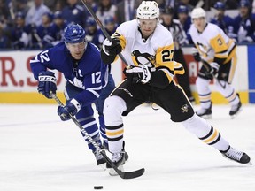 Toronto Maple Leafs centre Patrick Marleau (12) and Pittsburgh Penguins centre Nick Bjugstad (27) battle for the puck during third period NHL hockey action in Toronto on Saturday, Feb. 2, 2019. THE CANADIAN PRESS/Nathan Denette
