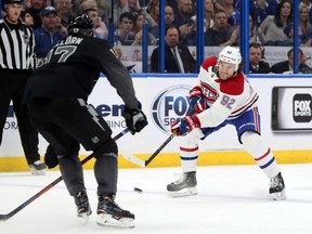 Canadiens' Jonathan Drouin skates in with puck against Tampa Bay Lightning's Alex Killorn during the second period at Amalie Arena in Tampa.