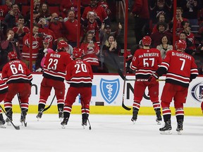 Carolina Hurricanes skate toward the crowd during a celebration following their win over the New Jersey Devils Sunday, Nov. 18, 2018, in Raleigh, N.C. (THE CANADIAN PRESS/AP, Karl B DeBlaker)