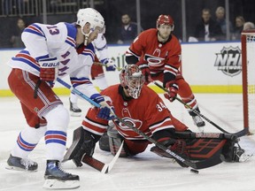 Carolina Hurricanes goaltender Petr Mrazek (34) stops a shot on the goal by New York Rangers' Kevin Hayes (13) during the second period of an NHL hockey game Friday, Feb. 8, 2019, in New York. (AP Photo/Frank Franklin II) ORG XMIT: MSG109