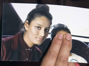In this file photo taken on Feb. 22, 2015 Renu Begum, eldest sister of missing British girl Shamima Begum, holds a picture of her sister while being interviewed by the media in central London.