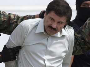 This Feb. 22, 2014 file photo shows Joaquin "El Chapo" Guzman, the head of Mexico's Sinaloa Cartel, being escorted to a helicopter in Mexico City following his capture in the beach resort town of Mazatlan.