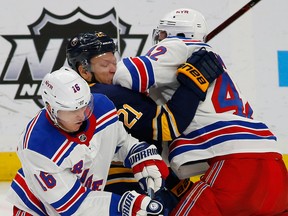 Buffalo Sabres forward Kyle Okposo is hit by New York Rangers Ryan Strome  and Brendan Smith during the third period of an NHL hockey game, Friday, Feb. 15, 2019, in Buffalo N.Y. Okposo has sustained his third concussion in less than three years.