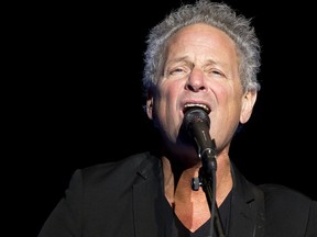 In this Dec. 5, 2018 file photo, Lindsey Buckingham performs at The Wilbur Theatre in Boston. Buckingham underwent open heart surgery that left the former Fleetwood Mac guitarist with damaged vocal cords.
