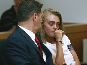 In a Thursday, Aug. 3, 2017 file photo, Michelle Carter awaits her sentencing in a courtroom in Taunton, Mass., for involuntary manslaughter for encouraging Conrad Roy III to kill himself in July 2014.