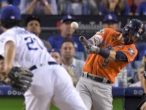 Houston Astros' Marwin Gonzalez hits a double off Los Angeles Dodgers starting pitcher Yu Darvish during Game 7 of the  World Series Wednesday, Nov. 1, 2017, in Los Angeles. (AP Photo/Mark J. Terrill)
