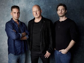 In this Jan. 24, 2019, file photo, Wade Robson, from left, director Dan Reed and James Safechuck pose for a portrait to promote the film "Leaving Neverland" at the Salesforce Music Lodge during the Sundance Film Festival in Park City, Utah.