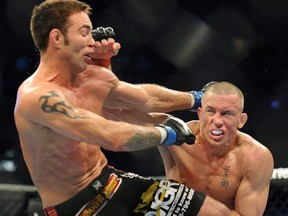 Fighters Georges St-Pierre, right, battles against Jake Shields during the welter weight championship match at UFC 129 in Toronto on Saturday, April 30, 2011.