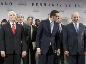 United States Vice President Mike Pence, Prime Minister of Poland Mateusz Morawiecki and Israeli Prime Minister Benjamin Netanyahu, from left, stand on a podium at a conference on Peace and Security in the Middle East in Warsaw, Poland, Thursday, Feb. 14, 2019.