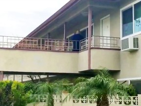 In this still image taken from video, an investigator is seen at the apartment building where authorities say a mother threw her young son from a second-story apartment landing and jumped herself as police arrived in Upland, Calif., Tuesday, Feb. 26, 2019. The mother and 1-year-old boy were hospitalized in stable condition, police said. A baby girl was found dead inside their apartment. (Beatriz Valenzuela/The Orange County Register/SCNG via AP) ORG XMIT: CAANR201