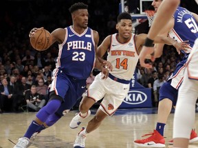 Philadelphia 76ers' Jimmy Butler drives past New York Knicks' Allonzo Trier during the first half of an NBA game, Wednesday, Feb. 13, 2019, in New York.
