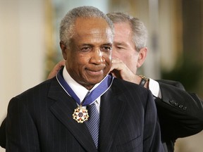 In this Nov. 9, 2005, file photo, President Bush awards baseball legend Frank Robinson the Presidential Medal of Freedom Award in the East Room of the White House in Washington.