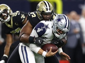 Dak Prescott of the Dallas Cowboys is sacked by David Onyemata of the New Orleans Saints at AT&T Stadium on November 29, 2018 in Arlington. (Ronald Martinez/Getty Images)