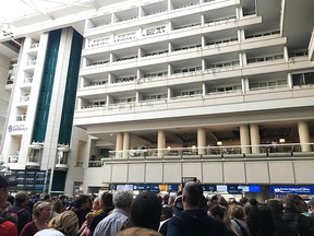 People wait to get through security at the Orlando International Airport following a security incident on Saturday, February 2, 2019. (THE CANADIAN PRESS/Jonathan Hayward)