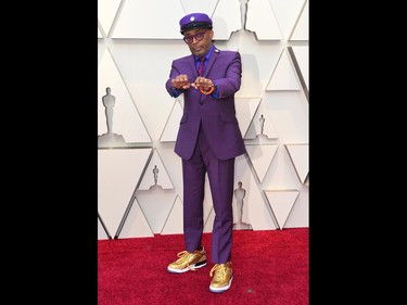 Spike Lee holds up brass knuckles reading "hate" and "love" from his iconic film "Do The Right Thing" as he arrives at the Oscars on Sunday, Feb. 24, 2019, at the Dolby Theatre in Los Angeles. (Jordan Strauss/Invision/AP)