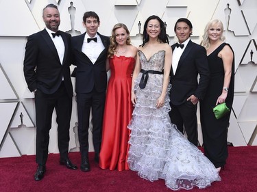 Evan Hayes, from left, Alex Honnold, Sanni McCandless, Elizabeth Chai Vasarhelyi, Jimmy Chin and Shannon Dill, from the cast and crew of "Free Solo," arrive at the Oscars on Sunday, Feb. 24, 2019, at the Dolby Theatre in Los Angeles. (Richard Shotwell/Invision/AP)