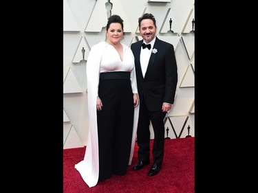 Melissa McCarthy, left, and Ben Falcone arrive at the Oscars on Sunday, Feb. 24, 2019, at the Dolby Theatre in Los Angeles. (Jordan Strauss/Invision/AP)