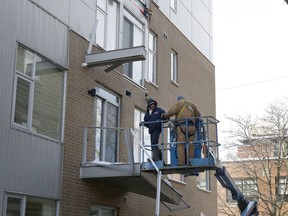 Crews dismantle the remains of three balconies that collapsed at the rear of a Patterson Ave.building Tuesday morning.