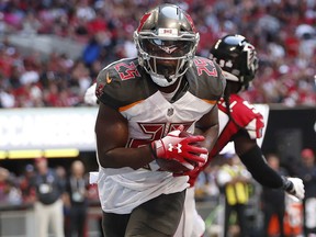 Tampa Bay Buccaneers running back Peyton Barber (25) scores a touchdown against the Atlanta Falcons Sunday, Oct. 14, 2018, in Atlanta. (AP Photo/John Bazemore)