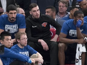 New York Knicks centre Enes Kanter. left, forward Mario Hezonja, centre, and guard Damyean Dotson, right, watch the game action from the bench during the first half of an NBA game against the Detroit Pistons, Tuesday, Feb. 5, 2019, at Madison Square Garden in New York.