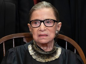 In this Nov. 30, 2018 file photo, Associate Justice Ruth Bader Ginsburg sits with fellow Supreme Court justices for a group portrait at the Supreme Court Building in Washington.