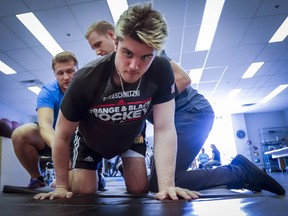 Humboldt Broncos bus crash survivor Ryan Straschnitzki attends a physiotherapy session with kinesiologist Kirill Dubrovskiy, left, and physiotherapist Nelson Morela, centre, in Calgary on August 20, 2018.