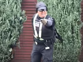A security guard motions to a photographer after shooting her outside the Etz Jacob Congregation/Ohel Chana High School in Los Angeles. (Video screen grab)