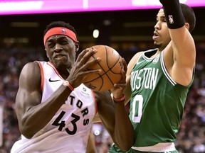 Raptors’ Pascal Siakam (left) drives past Celtics’ Jayson Tatum last night during Toronto’s convincing win on Tuesday.  THE CANADIAN PRESS