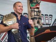 UFC Champion Georges St-Pierre shows off the 2009 Ultimate Fighting Championship title belt that the Canadian Museum of History has acquired and which will become part of the permanent exhibition.