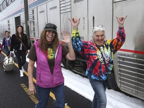 Patricia Bailey, centre, and Annette Saba, right, celebrate as they disembark an Amtrak passenger train in Eugene, Ore. Tuesday, Feb. 26, 2019. (AP Photo/Chris Pietsch)