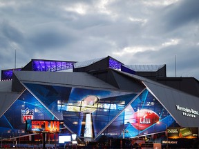 Mercedes-Benz Stadium is lit up ahead of Sunday's NFL Super Bowl 53 football game between the Los Angeles Rams and New England Patriots in Atlanta, Saturday, Feb. 2, 2019. (AP Photo/) ORG XMIT: GADG106