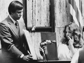 In this July 18, 1979 file photo, Nita Jane Neary, right, looks at drawing in court as prosecution attorney Larry Simpson holds additional prints during the murder trial of Ted Bundy in Miami, Fla. (AP Photo/Pool)