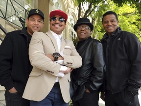 In this Tuesday, Feb. 26, 2019, Marlon Jackson, second from left, Tito Jackson, second from right, and Jackie Jackson, far right, brothers of the late musical artist Michael Jackson, and Tito's son Taj, far left, pose together for a portrait outside the Four Seasons Hotel, in Los Angeles.