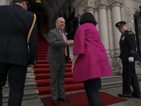 B.C. Premier John Horgan greets Lt.-Gov. Janet Austin on the steps of Legislature before the speech from the throne in the legislative assembly in Victoria, B.C., on Tuesday, Feb.  12, 2019.