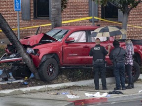 Fullerton Police investigate an early-morning accident that injured several pedestrians, Sunday, Feb. 10, 2019, in Fullerton, Calif. Authorities say a suspected drunken driver was arrested after his pickup truck plowed into a crowd on a sidewalk, injuring multiple people, including some victims who were trapped under the vehicle. (Mindy Schauer/The Orange County Register via AP) ORG XMIT: CAANR102