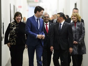 Prime Minister Justin Trudeau walks with BlackBerry CEO John Chen as he arrives at BlackBerry QNX Headquarters in Ottawa on Friday, Feb 15, 2019. (CANADIAN PRESS/Sean Kilpatrick)