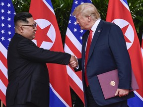 In this June 12, 2018, file photo, North Korea leader Kim Jong Un, left, and U.S. President Donald Trump shake hands at the conclusion of their meetings at the Capella resort on Sentosa Island in Singapore. (AP Photo/Susan Walsh, Pool, File)