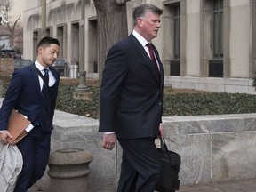 Kevin Downing, Paul Manafort's defense attorney, right, walks to the entrance of federal court on Wednesday, Feb. 13, 2019 in Washington. At left is attorney Tim Wang, another member of the defense team for Manafort.