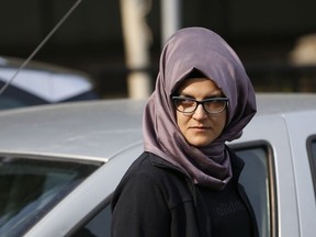 In this Wednesday, Oct. 3, 2018 file photo, Hatice Cengiz, the Turkish fiancee of Saudi journalist Jamal Khashoggi, stands outside the Saudi Arabia consulate in Istanbul the day after his killing. Turkey's state-run news agency is quoting a police report Thursday, Feb. 14, 2019 suggesting that Cengiz may have escaped being a second victim of the killing.