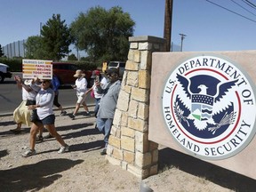 This June 2018 file photo shows protesters walking along Montana Avenue outside the El Paso Processing Center, in El Paso, Texas.