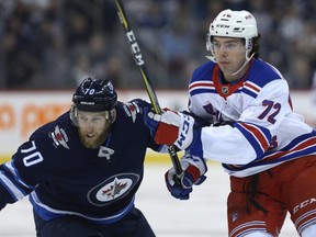 Winnipeg Jets defenceman Joe Morrow (left) tries to slow New York Rangers centre Filip Chytil in Winnipeg on Tues., Feb. 12, 2019. Kevin King/Winnipeg Sun/Postmedia Network