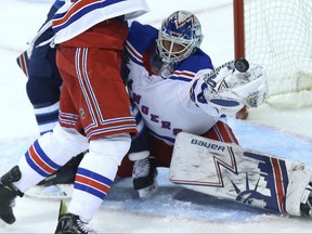 Rangers goaltender Henrik Lundqvist makes a glove save with traffic in front against the Jets on Tuesday night. Kevin King/Winnipeg Sun/Postmedia Network