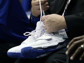A trainer holds Duke's Zion Williamson's shoes after Williamson left the game due to an injury against North Carolina in Durham, N.C., Wednesday, Feb. 20, 2019. (AP Photo/Gerry Broome)