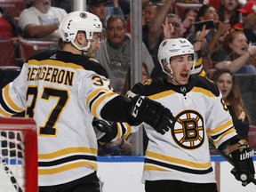 Boston Bruins  Patrice Bergeron, right, congratulates Brad Marchand after he scored a second period goal against the Florida Panthers at the BB&T Center on March 23, 2019 in Sunrise, Fla. (Joel Auerbach/Getty Images)